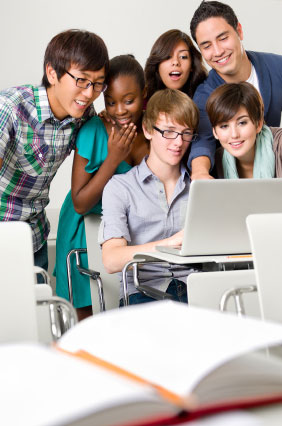 A group of students looking at something on a computer